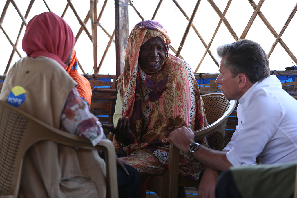 The UN's Emergency Relief Coordinator, Tom Fletcher, meets women at a site hosting displaced people in Tawila, Darfur.